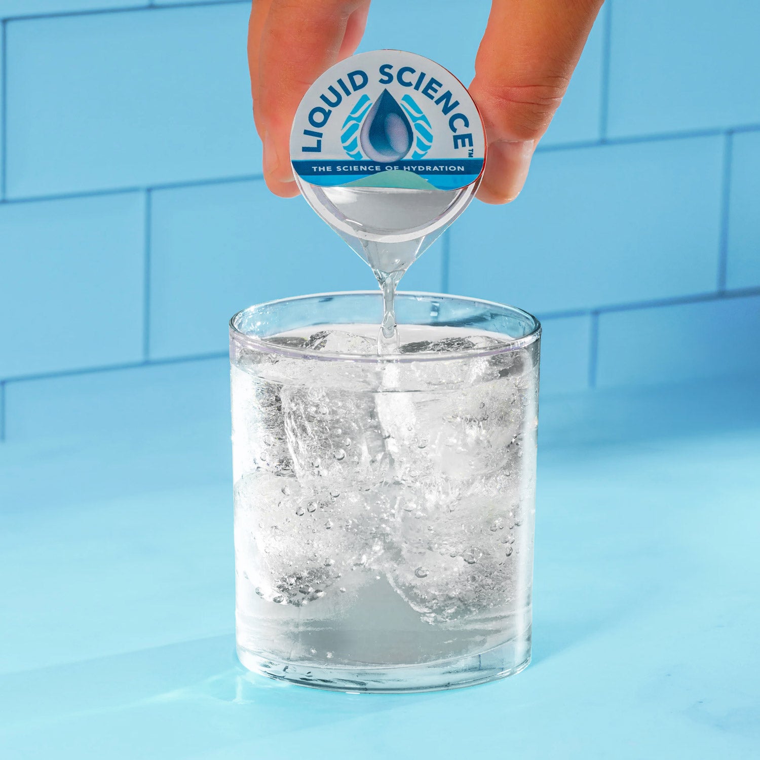 liquid science clear being added to glass of club soda
