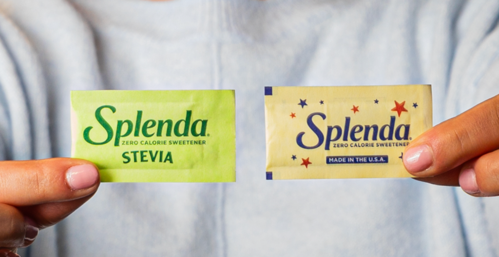 Person holding Splenda Sweetener and Splenda Stevia packets